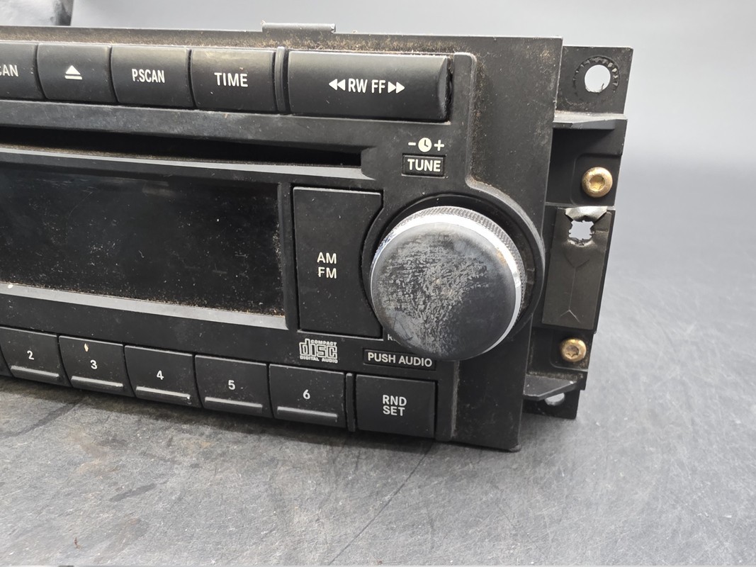 OEM 04-10 Chrysler Dodge Jeep Radio CD AUX Input 05064171AF Used
