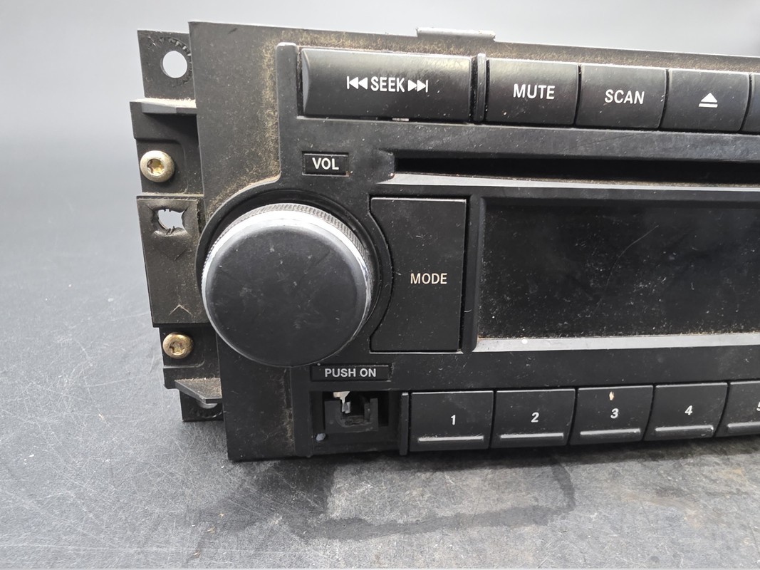OEM 04-10 Chrysler Dodge Jeep Radio CD AUX Input 05064171AF Used